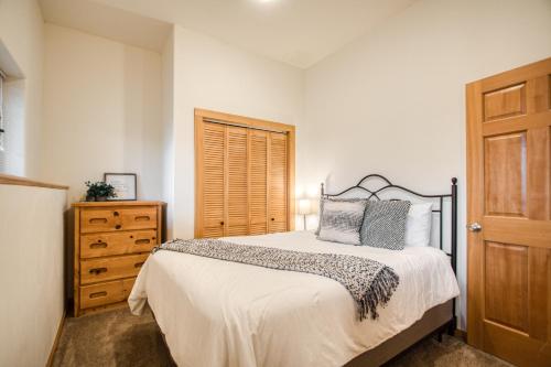 a bedroom with a bed and a wooden door at Sagle Sunrise in Sagle
