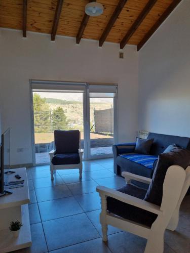 a living room with a couch and a chair at Los Reales in Esquel