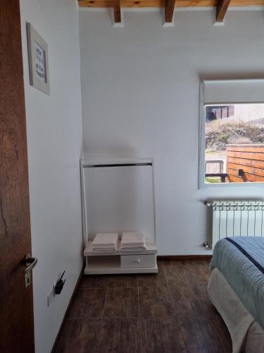 a bedroom with a bed and a mirror on the wall at Los Reales in Esquel