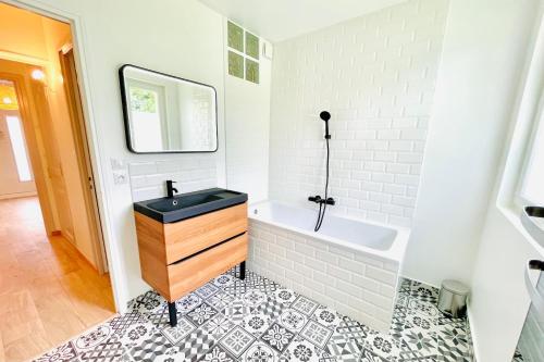 a bathroom with a sink and a bath tub at VILLA EDOUARD - 180m2 in nature & forest - 20min Disney - 7min airport in Claye-Souilly