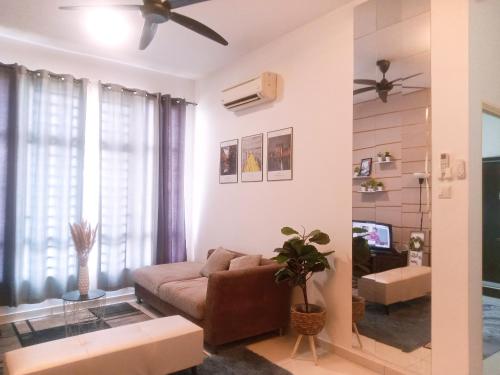 a living room with a couch and a ceiling fan at Homestay El@sya JB-Apartment 1 bedroom in Johor Bahru