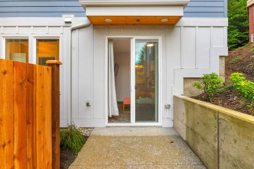 a house with a white door and a wooden fence at Skywalker Rebel Base in Seattle