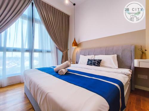 a bedroom with a large bed with a large window at Skudai Paradigm Mall by RR JBcity in Johor Bahru