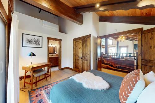 a bedroom with a blue bed and a desk and a desk at Pine Haven Retreat in Stateline