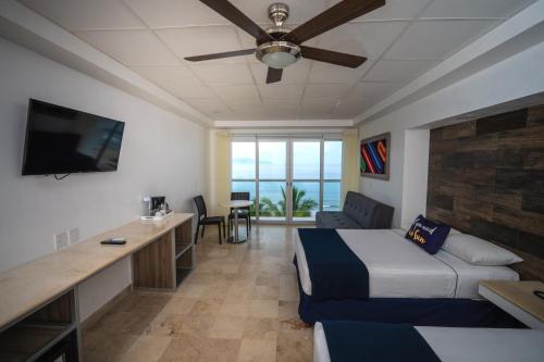a hotel room with a bed and a flat screen tv at Hotel Villa Varadero in Nuevo Vallarta 