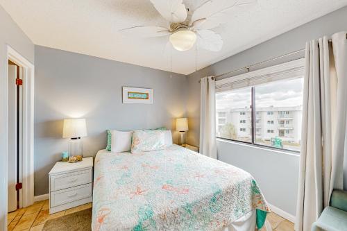 a bedroom with a bed and a window at Plantation East II in Gulf Shores