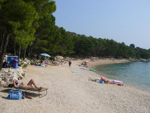 a group of people laying on a beach at Holiday house with a parking space Drage, Biograd - 21287 in Pakoštane