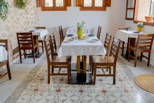 a dining room with two tables and chairs at Can Colom in Banyalbufar