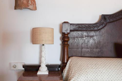 a lamp sitting on a table next to a bed at Can Colom in Banyalbufar
