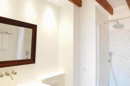 a bathroom with a mirror and a shower at Hotel D' Interior Can Colom in Banyalbufar