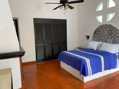 a bedroom with a bed and a ceiling fan at Casa Yollotzin in Ajijic
