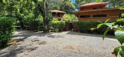 a house with a driveway in front of a building at Boutique Hotel y Spa Tangara Azul in Ojochal