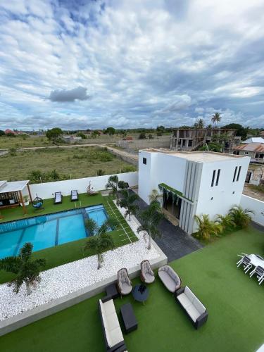 an aerial view of a house with a swimming pool and lawn at Kibada White Villa in Dar es Salaam