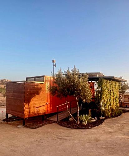 a house that is sitting next to a tree at Xaroma in Valle de Guadalupe