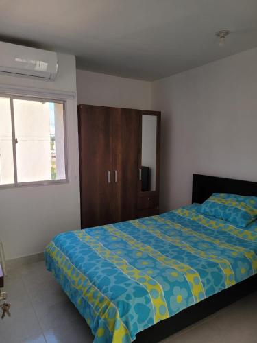 a bedroom with a bed and a cabinet and a window at Apartamento Tranquilo para Descansar in Sincelejo