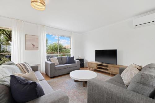 a living room with two couches and a tv at Lazy Daze at SummerHaze in Cape Woolamai
