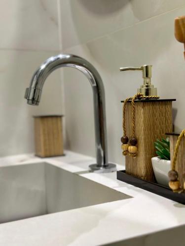 a kitchen counter with a sink with a faucet at Canto do Forte experience in Praia Grande