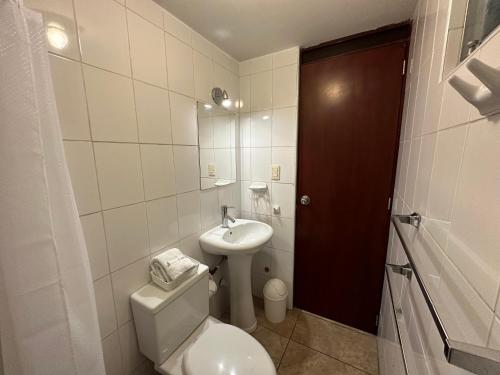 a bathroom with a toilet and a sink at Hotel Piru Wasi in Arequipa