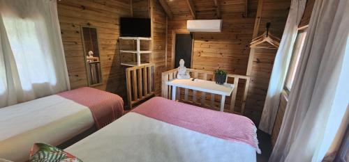 a small room with two beds and a table at Boutique Hotel y Spa Tangara Azul in Ojochal