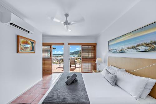 a bedroom with a bed and a view of the ocean at Spa Haven 17A in Airlie Beach