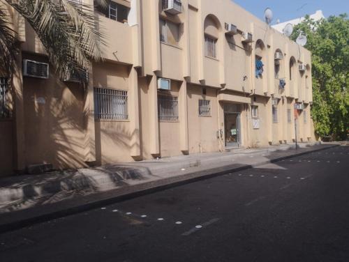 an empty street next to a large building at Sphinx Hostel in Dubai