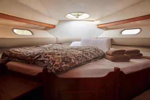 a bed in the back of a boat with towels at cuchi-barco in Madrid