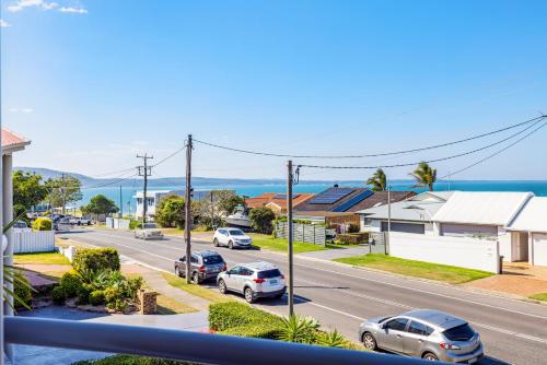 a view of a street with cars parked on the road at Sunrise Serenity in Salamander Bay