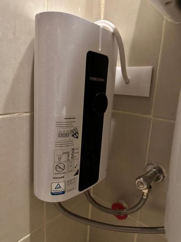 a cell phone is plugged into a dispenser on a wall at Studio Room Blissful Cradle at One Regis-Upper East in Bacolod