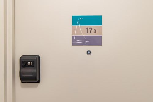 a clock on a door with a thermometer on it at Spa Haven 17B Ocean View in Airlie Beach