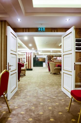an open door in a room with chairs and tables at Royal Hotel Inegol in Inegol