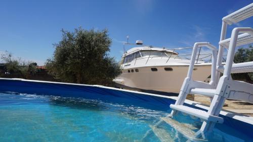 a boat parked next to a pool with a chair at cuchi-barco in Madrid