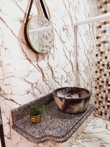 a bathroom with a tub on a counter with a mirror at Flat 2 Marias in Maragogi