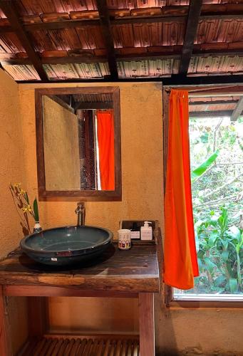 a bathroom with a sink and a mirror at Boong House in Bao Loc