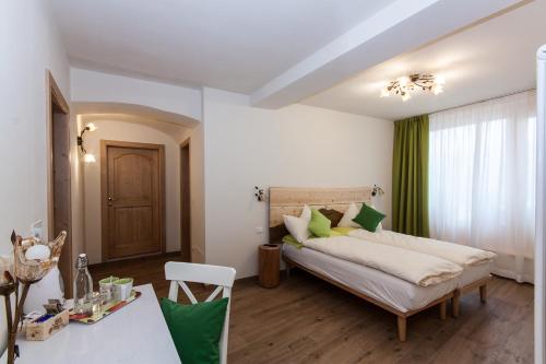 a bedroom with a bed and a table in a room at B&B Incanto in Cles