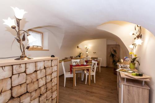 a kitchen and dining room with a stone wall at B&B Incanto in Cles