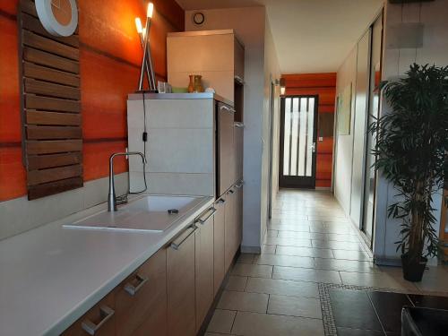 a kitchen with a sink and a refrigerator at Charmant T2 rénové à Capbreton à 2 min de la plage avec parking privé - FR-1-239-901 in Capbreton