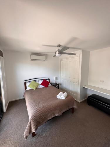 a bedroom with a bed and a ceiling fan at Bundalong Villas in Bundalong