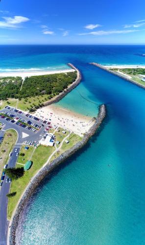 an aerial view of a beach and the ocean at 3 of 33 Wharf Street in Tuncurry