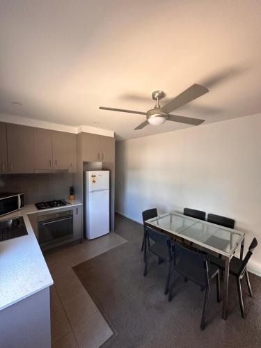 a kitchen with a table and a white refrigerator at Bundalong Villas in Bundalong