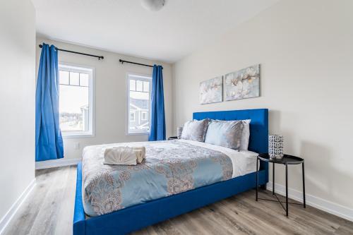 a bedroom with a blue bed and blue curtains at Luxury Town close to Fairview Casino in Niagra Falls in Niagara Falls