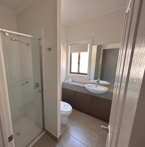 a bathroom with a shower and a toilet and a sink at Bundalong Villas in Bundalong
