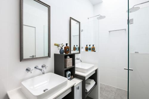 a bathroom with two sinks and a shower at Pacific Dawn on the Beach One in Wooli