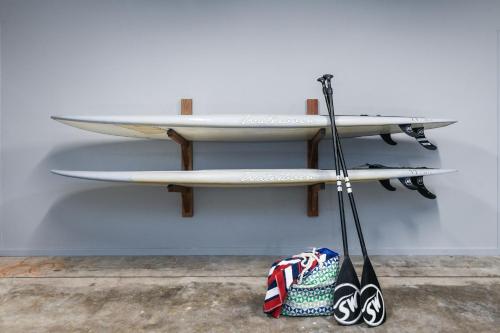 three surfboards on a shelf on a wall at Pacific Dawn on the Beach One in Wooli
