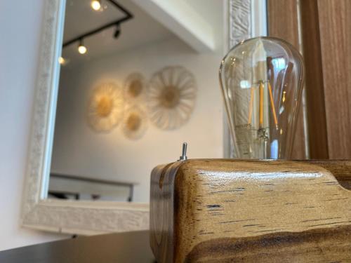 a glass vase sitting on a table in front of a mirror at Studio da fonte/Vista mar in Salvador