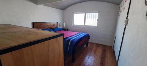 a small bedroom with a bed and a window at YAXCHILAN 27 in Cancún