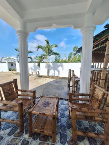 a porch with chairs and a view of the beach at JOE'S CASTLE in Sagbayan