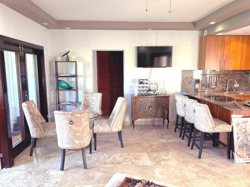 a kitchen with a table and chairs and a counter at Come, Enjoy & Relax at Rio Mar Cluster II, Rio Grande, PR in Rio Grande