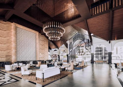 a lobby with white furniture and a large chandelier at Bertam Resort & Water Park Penang in Kepala Batas
