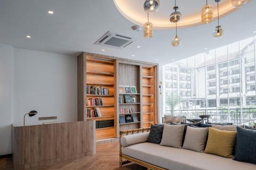 a living room with a couch and a book shelf at Bertam Resort,Penang in Kepala Batas