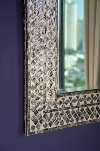 a mirror on a wall next to a window at The Arabian Nights B&B in Chongqing